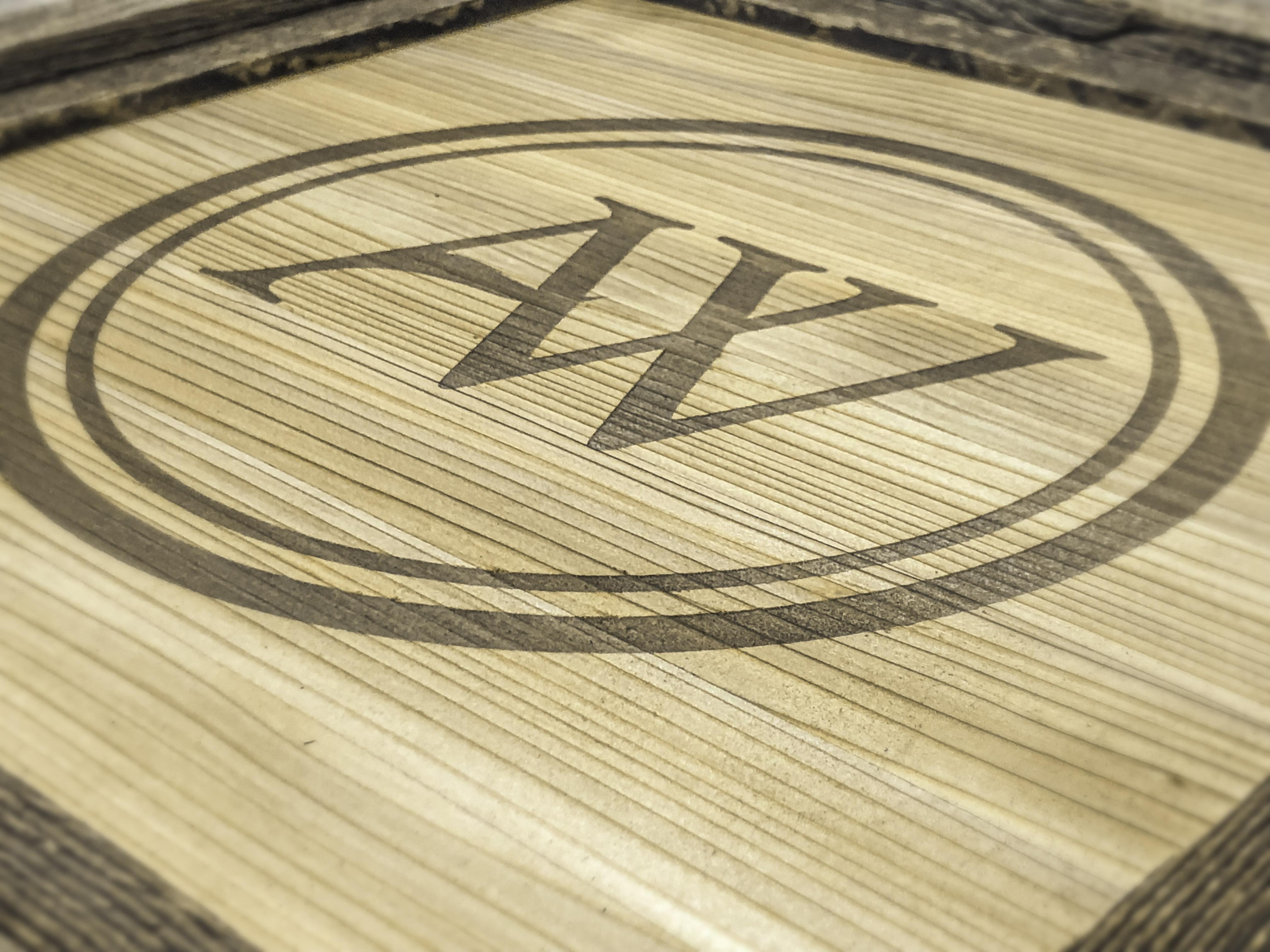 Custom framing of an engraved Advanced Woodwork logo. 