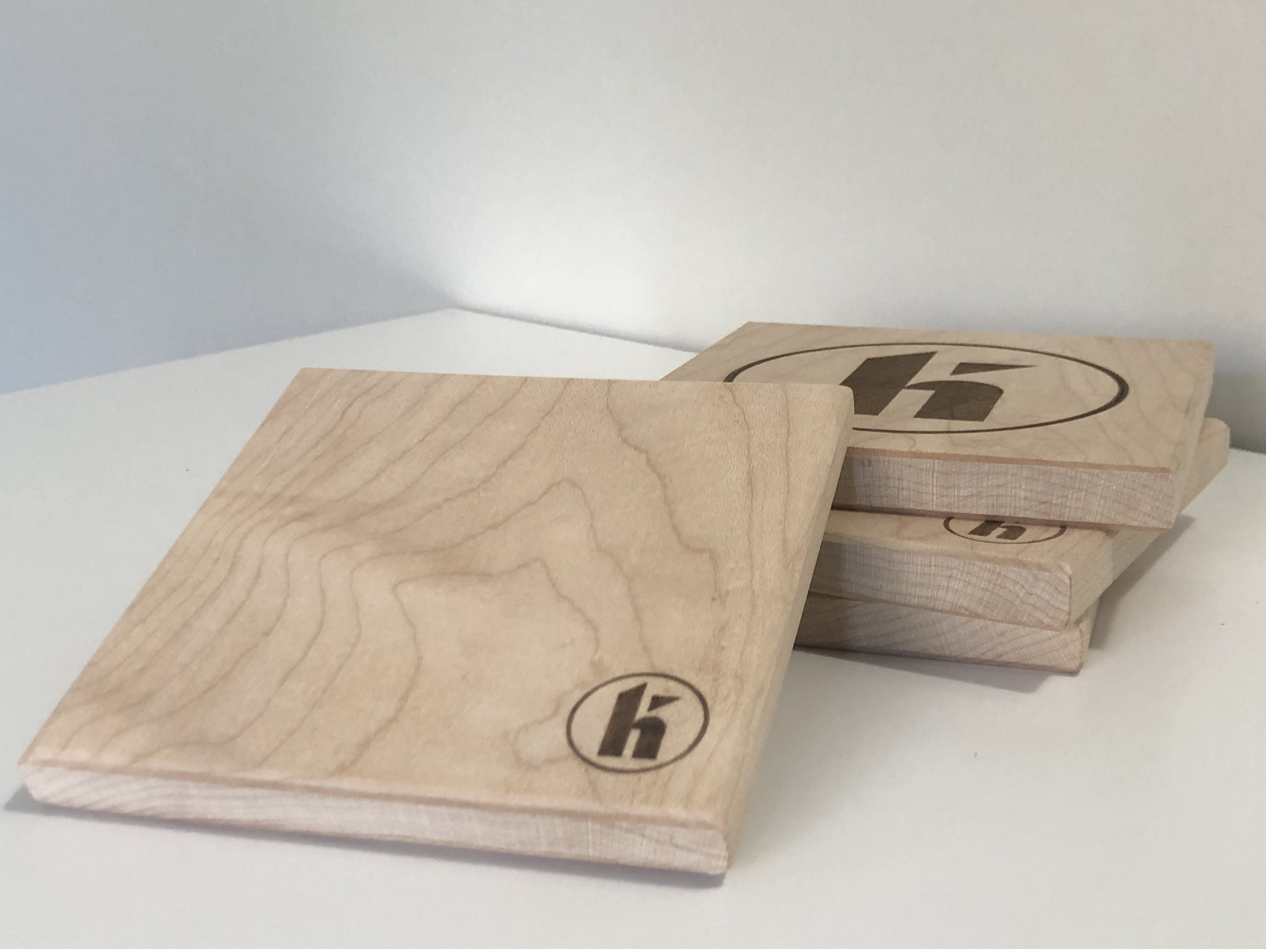 Handmade wood coasters with custom engraving.